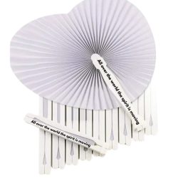 White heart-shaped paper hand fan with “All over the world the Spirit is moving” printed on the handle